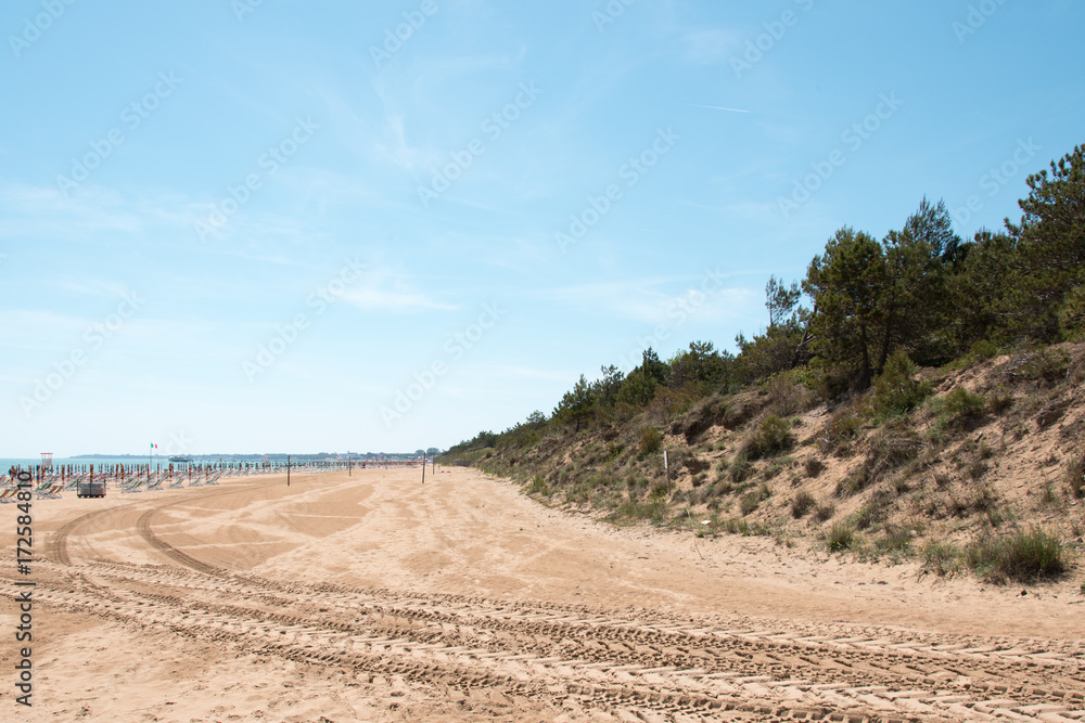 Lignano Sabbiadoro. Lighthouse, beach and umbrellas. Lignano Sabbiadoro. Lighthouse, beach and umbrellas.