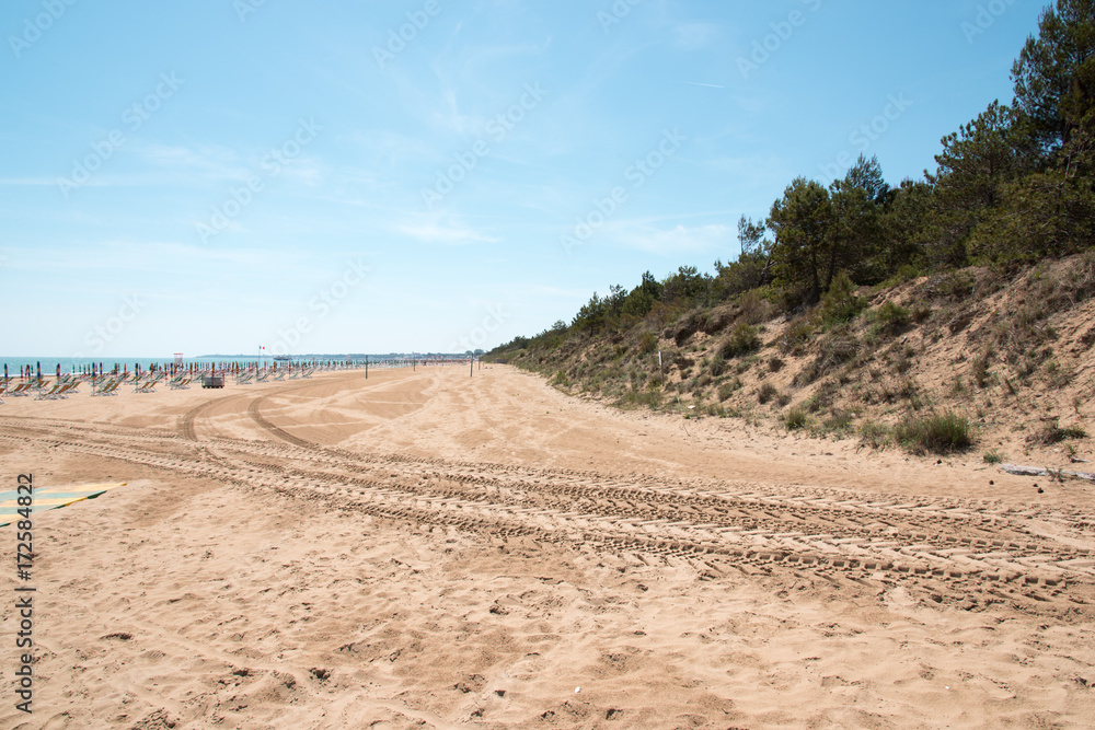 Lignano Sabbiadoro. Lighthouse, beach and umbrellas. Lignano Sabbiadoro. Lighthouse, beach and umbrellas.