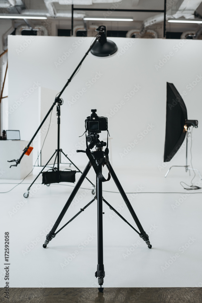 camera in photo studio with lighting equipment