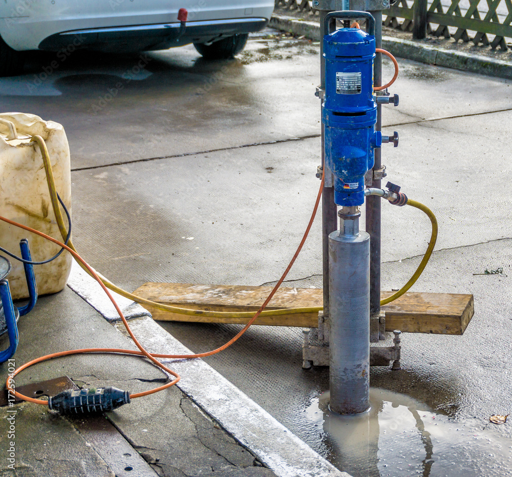 Core drilling machine for drilling a concrete base at a filling station Core drilling machine for drilling a concrete base at a filling station