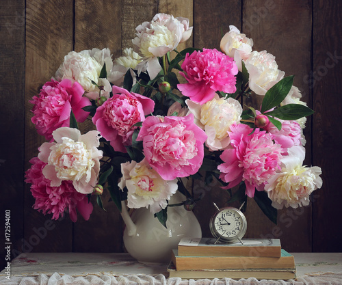 Bouquet of peonies in a white pitcher.