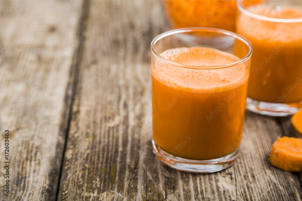 Carrot juice on a wooden table. Carrot juice on a wooden table.
