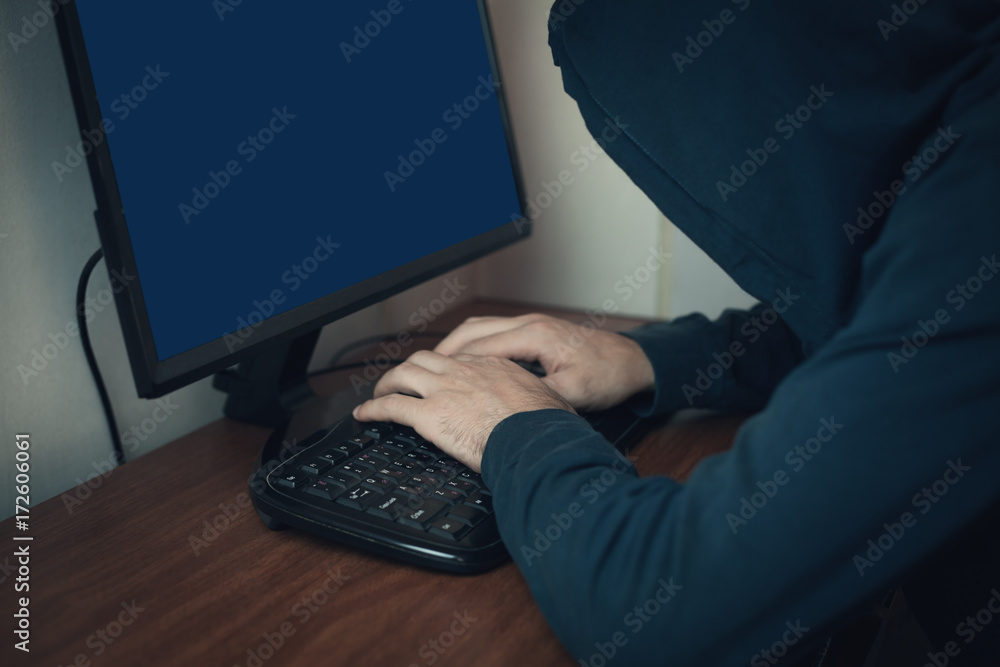Hacker working on computer. Hacker working on computer.