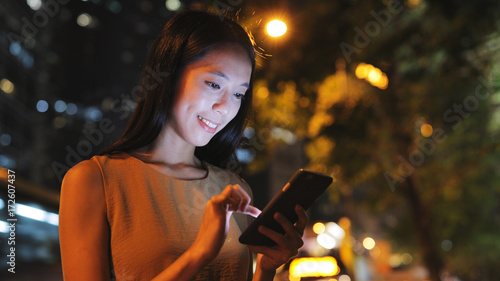 Photography Woman using mobile phone in city at night