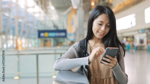 Woman working on mobile phone in the station