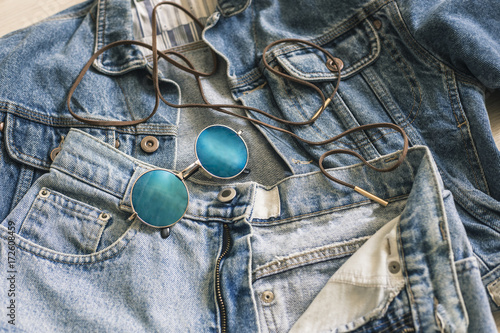 Trendy blue circle sunglasses on the jeans and jacket photo