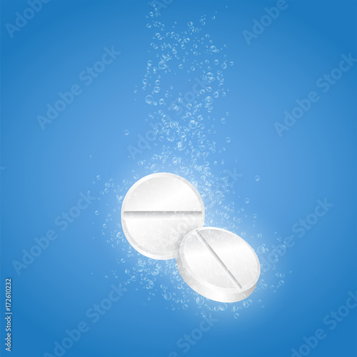 Two pills with bubbles in water