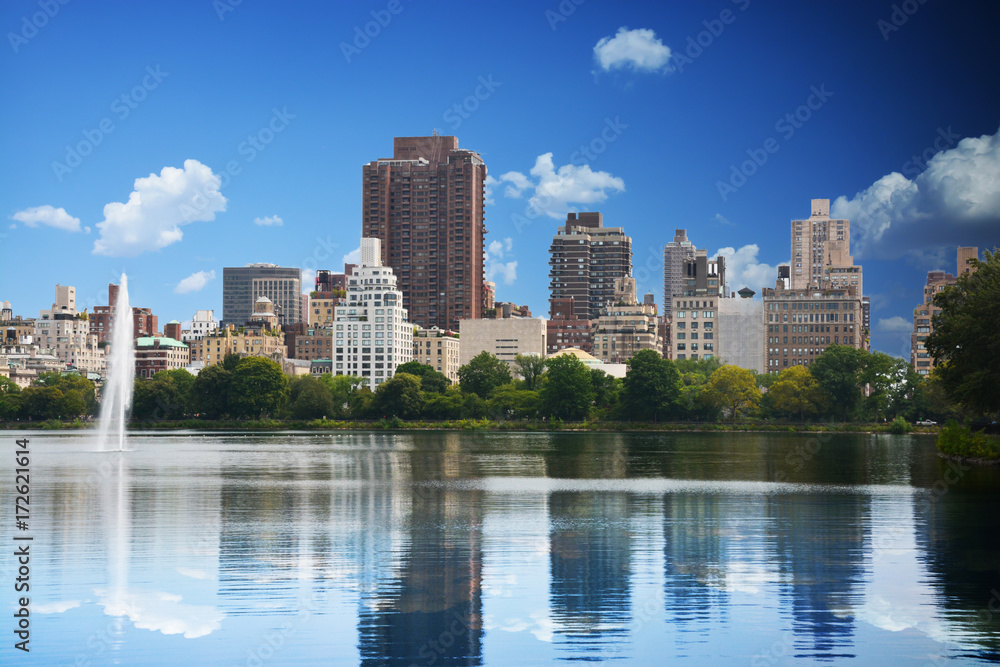 New York skyline reflected in Central Park lake in summer time New York skyline reflected in Central Park lake in summer time