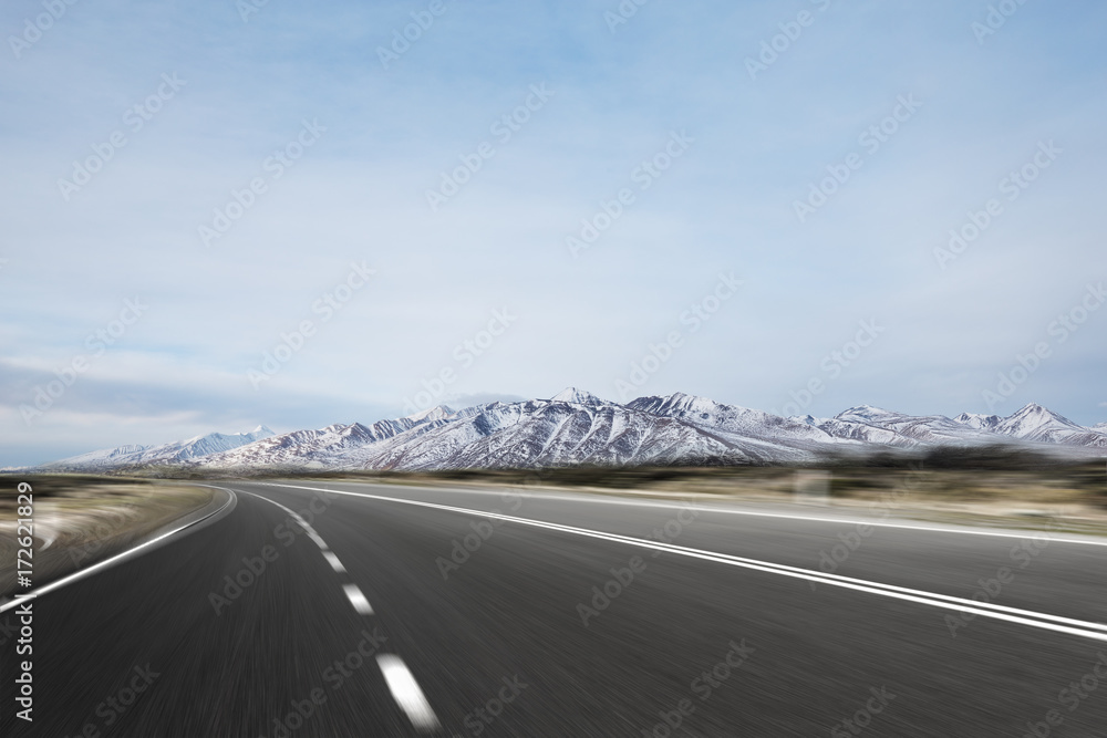 Fototapeta premium empty asphalt road with beautiful snow mountains