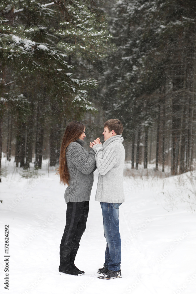 pair of lovers on a date winter afternoon in a snow blizzard pair of lovers on a date winter afternoon in a snow blizzard