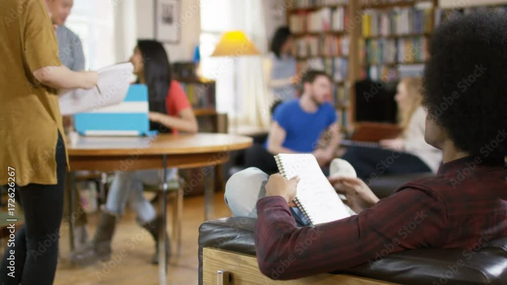 Group of students studying and relaxing together in shared accommodation. Group of students studying and relaxing together in shared accommodation.
