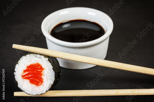 Sushi roll with chopsticks and soy sauce