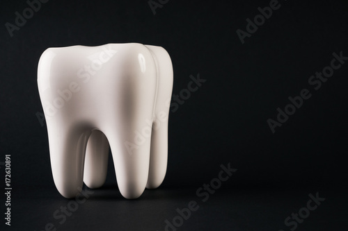 White healthy Tooth isolated on black background