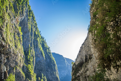 The sun shines through the gorge in the mountains photo