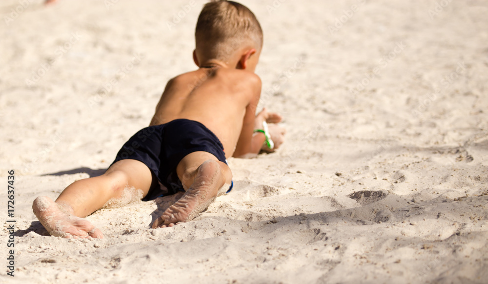 Feet of a boy playing in the sand Feet of a boy playing in the sand