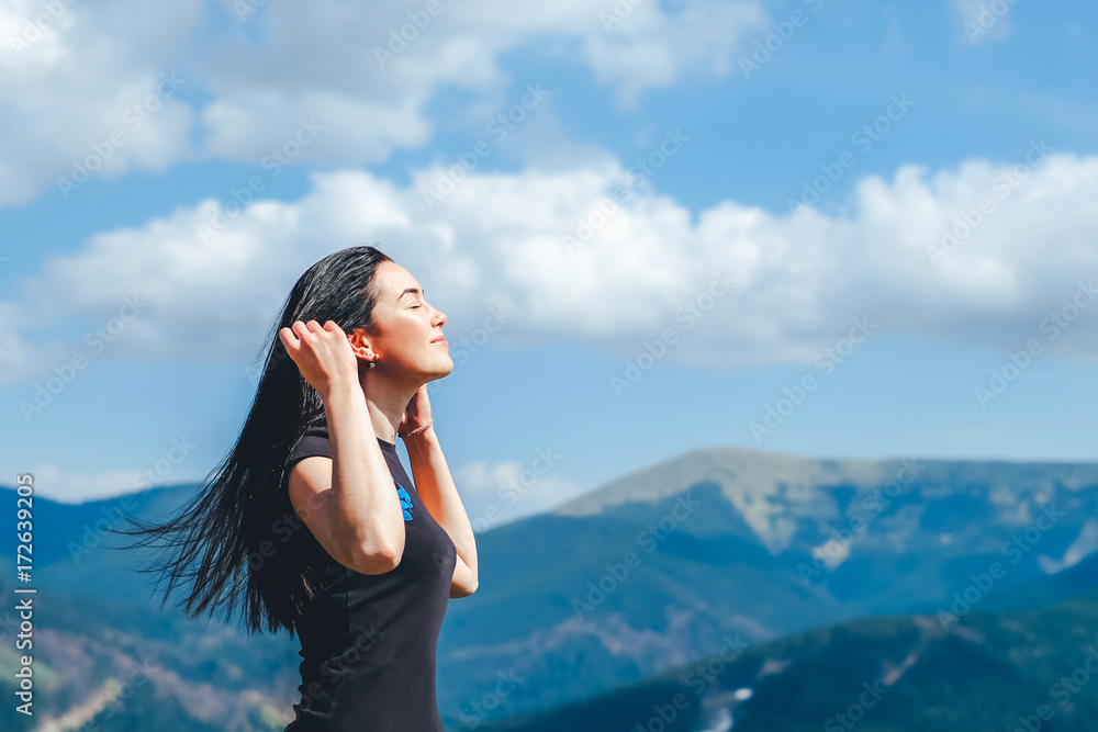 brunette girl on the top of the mountain enjoying fresh air brunette girl on the top of the mountain enjoying fresh air