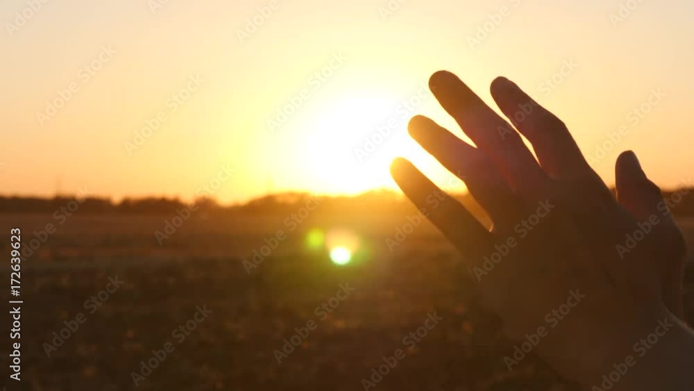 Hand at sunset. A man's hand from the window of a car in the sun's rays Hand at sunset. A man's hand from the window of a car in the sun's rays