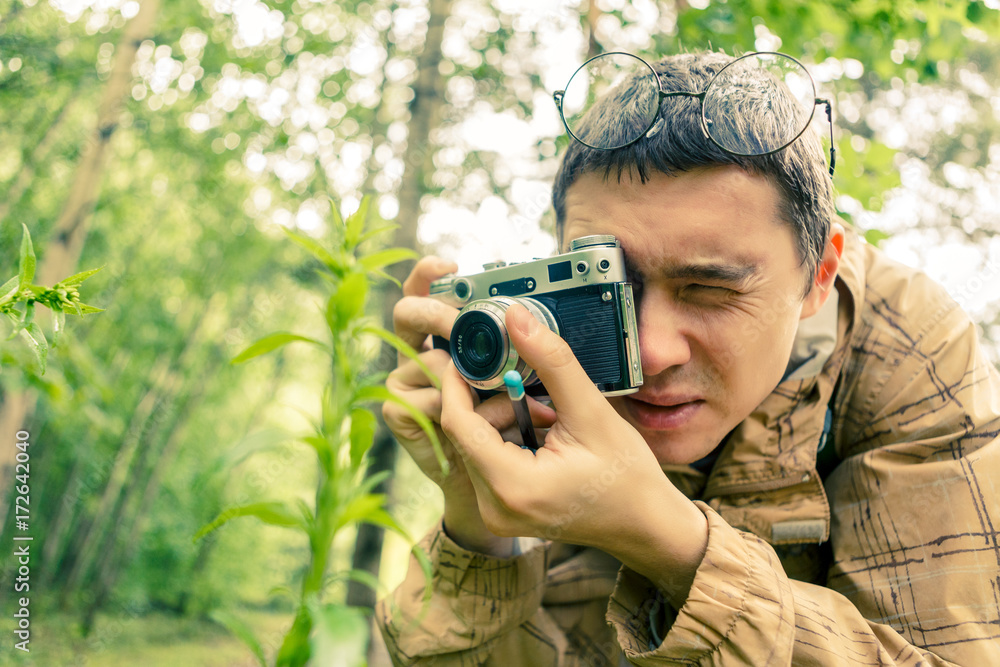 Picture of brunet with camera in woods Picture of brunet with camera in woods