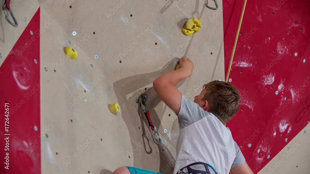 A boy is really good at climbing. He almost made it to the very top. He is having PE in school. A boy is really good at climbing. He almost made it to the very top. He is having PE in school.
