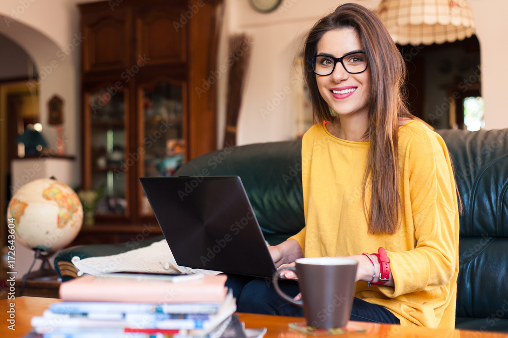 Woman sitting on the couch using a laptop. Woman sitting on the couch using a laptop.
