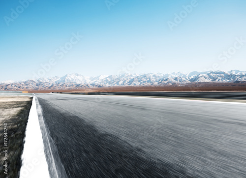 empty asphalt road with beautiful snow mountains © zhu difeng