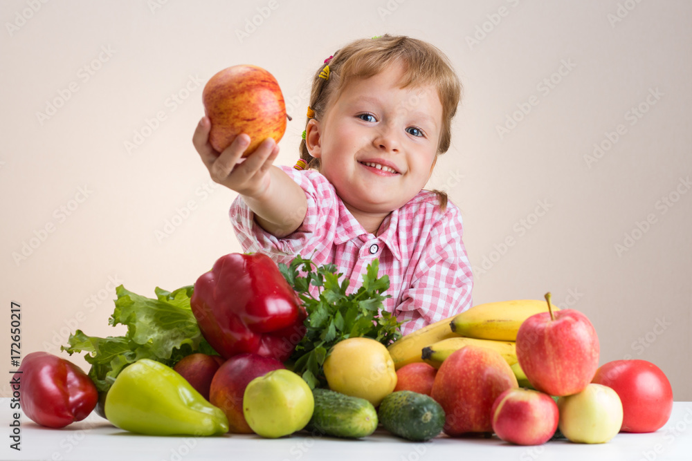 Fototapeta premium Happy little girl and a lot of fruit and vegetables.