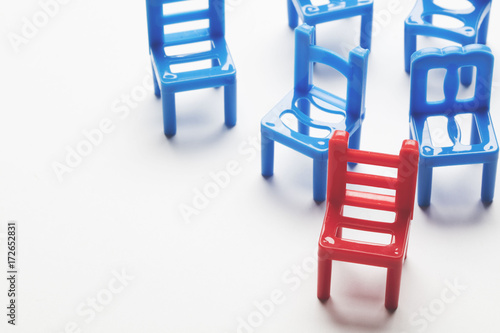 Collection of chairs with one odd one out.  photo