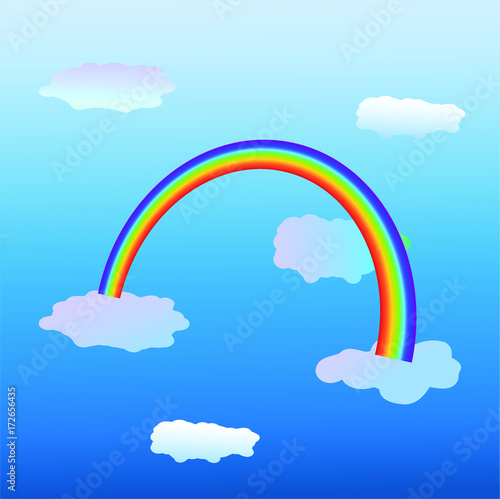 Rainbow against blue sky with clouds