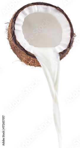 Coconut milk pouring out of coconut fruit.