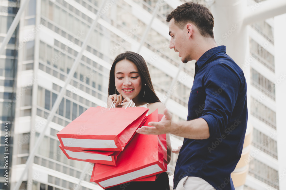 Asian woman with shopping bag and boyfriend surprise Asian woman with shopping bag and boyfriend surprise