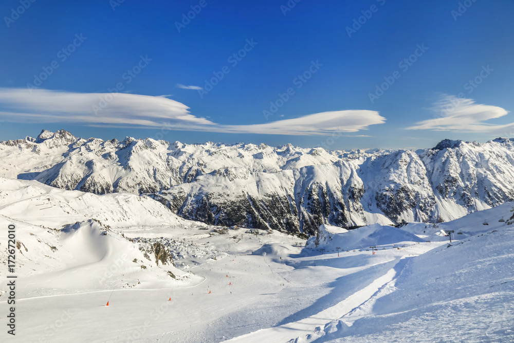 Panoramic landscape of ski resort valley with amazing beautiful mountains and dramatic cloudy sky on the background in Austria