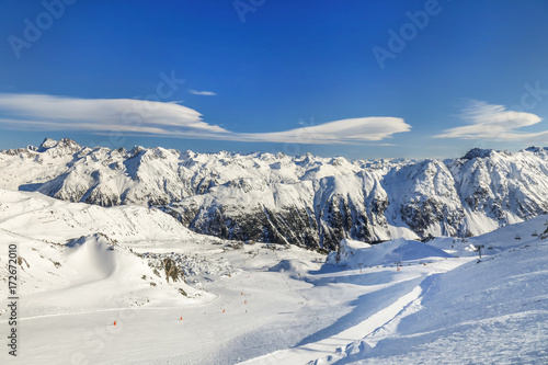 Panoramic landscape of ski resort valley with amazing beautiful mountains and dramatic cloudy sky on the background in Austria © Kirill Gorlov