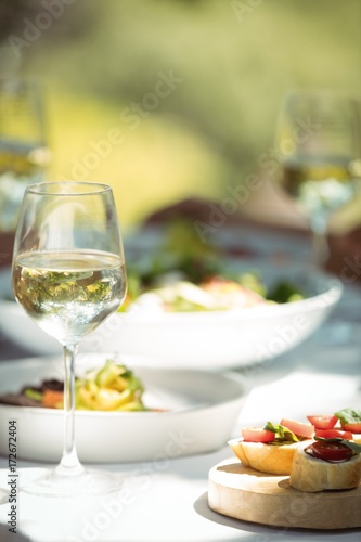 Close-up of food and wine glass on dining table