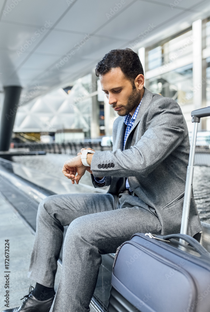 Businessman checking the time in the city Businessman checking the time in the city