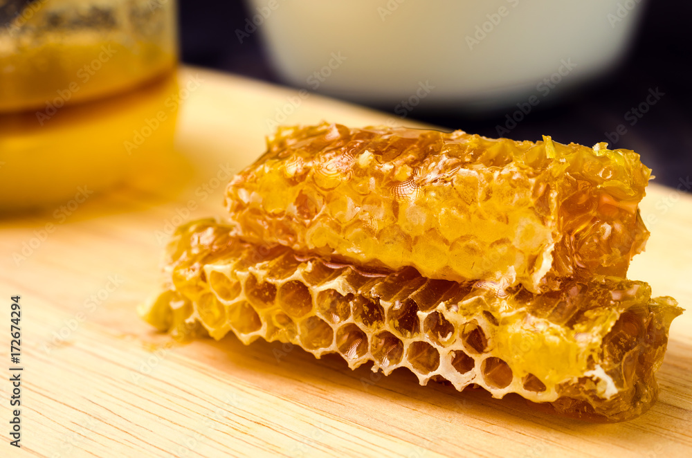 honey in honeycombs on a wooden support/honey in honeycombs on a wooden support toned honey in honeycombs on a wooden support/honey in honeycombs on a wooden support toned