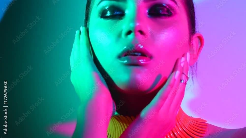 Fashion model woman in colorful bright lights posing in studio, portrait of beautiful sexy girl with trendy make-up and manicure. 4K UHD video 3840x2160 Fashion model woman in colorful bright lights posing in studio, portrait of beautiful sexy girl with trendy make-up and manicure. 4K UHD video 3840x2160