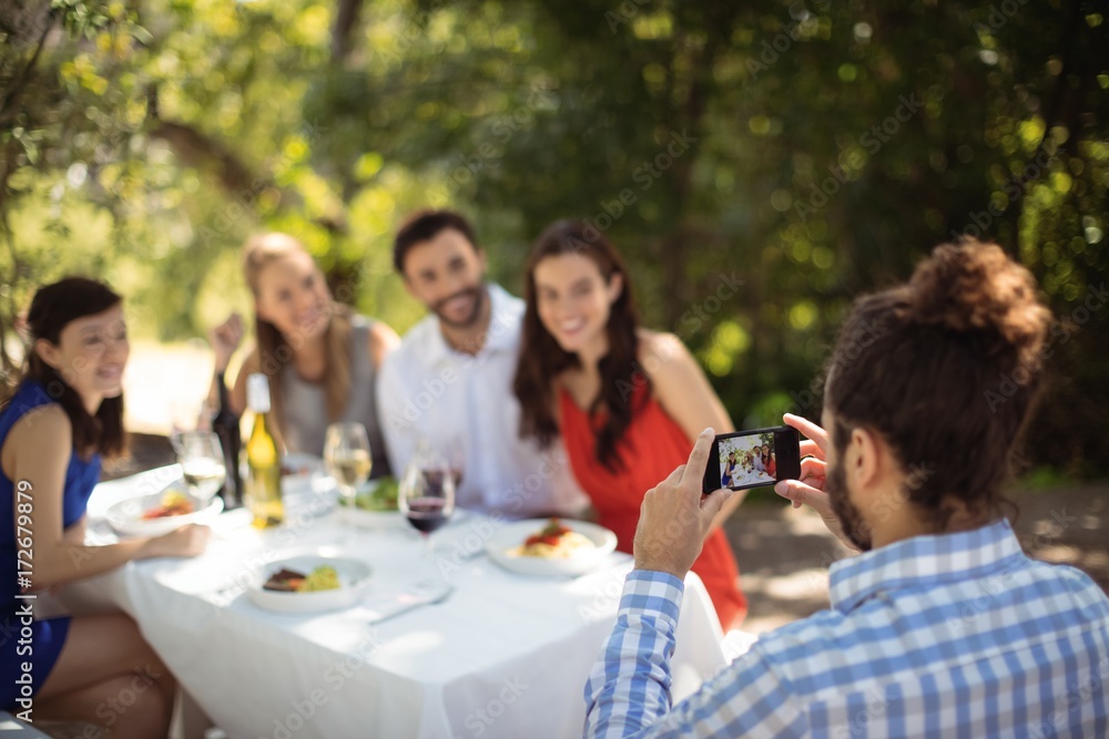 Man clicking photograph of his friends Man clicking photograph of his friends