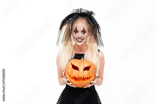 Smiling mad woman dressed in black widow costume