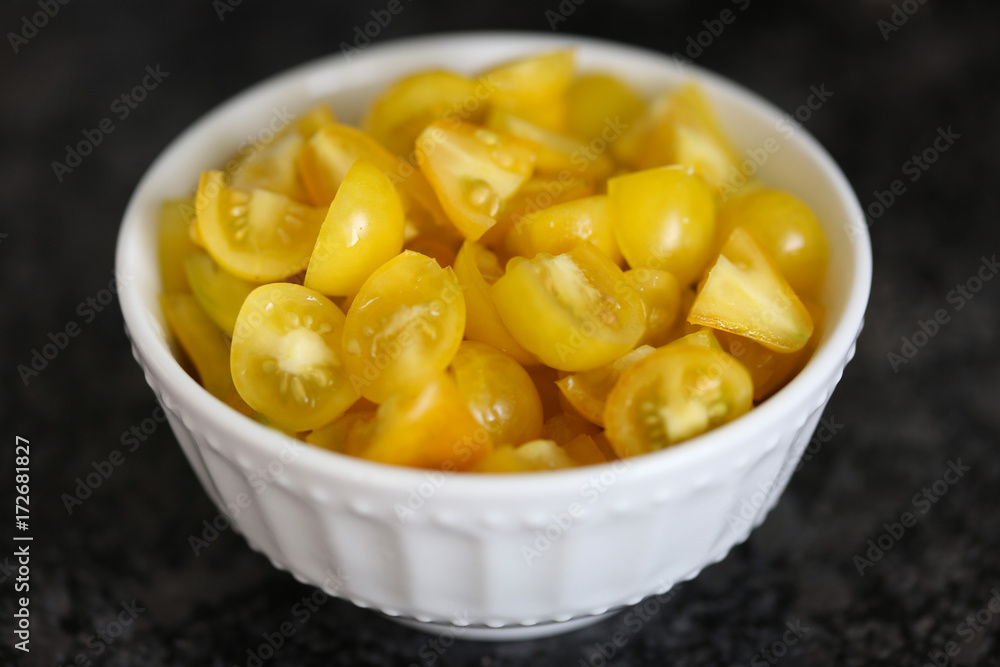 Bowl of chopped heirloom yellow pear tomatoes. Bowl of chopped heirloom yellow pear tomatoes.