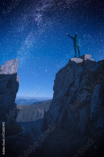 Man standing on a edge of rocky cliff