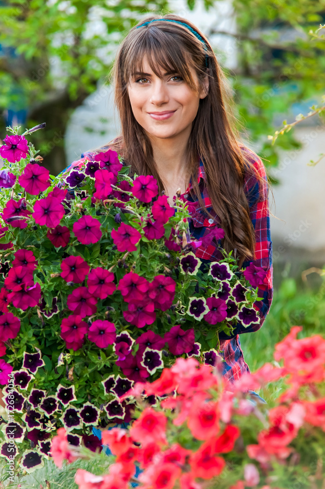 Young woman planting flowers in the garden. Young woman planting flowers in the garden.