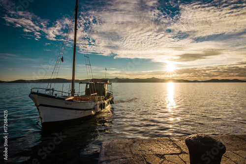 Old Boat Arrives at sunset