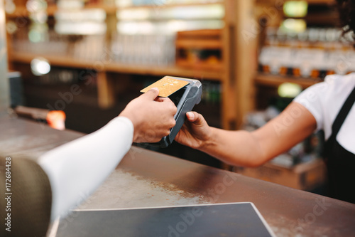 Customer paying bill using card photo