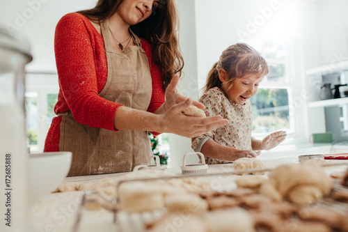 Mother and child making cookies for Christmas.