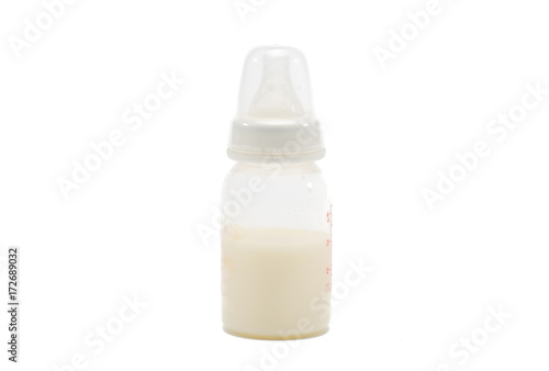 Fresh breast milk in the bottle on white
