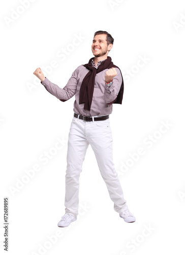 Excited handsome man with arms raised in success - Isolated