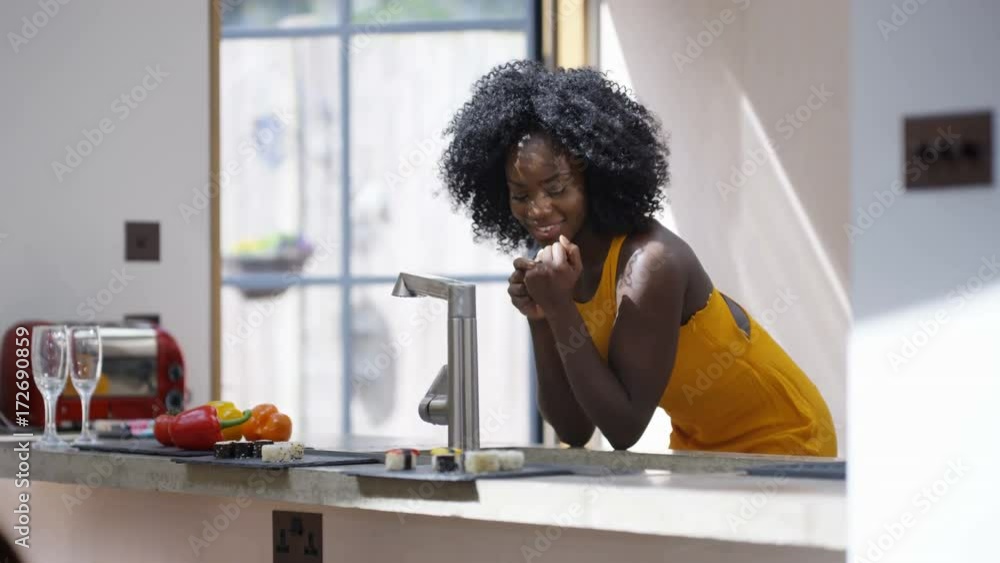 Happy newly engaged woman admiring her ring, in the kitchen at home. Happy newly engaged woman admiring her ring, in the kitchen at home.