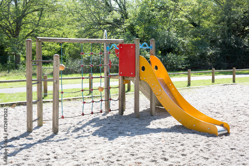 Big colorful children playground equipment in park - obrazy, fototapety, plakaty 