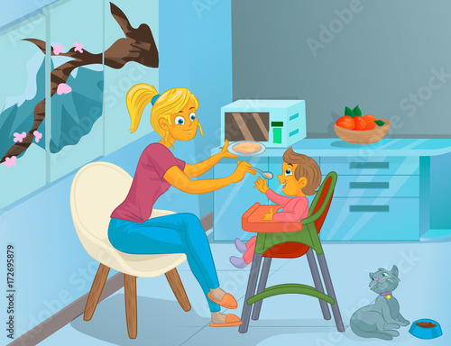 Nanny in the kitchen is feeding the child