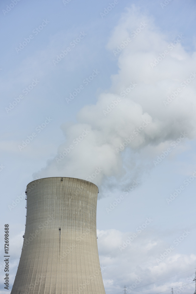 nuclear power plant chimney with condensation smoke on a cloudy day nuclear power plant chimney with condensation smoke on a cloudy day